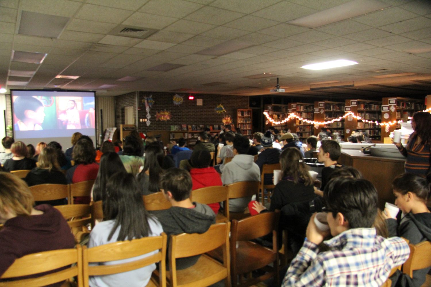 The audience enjoys some hot cocoa at the Polar Express Night hosted by the Argo Ambassadors.