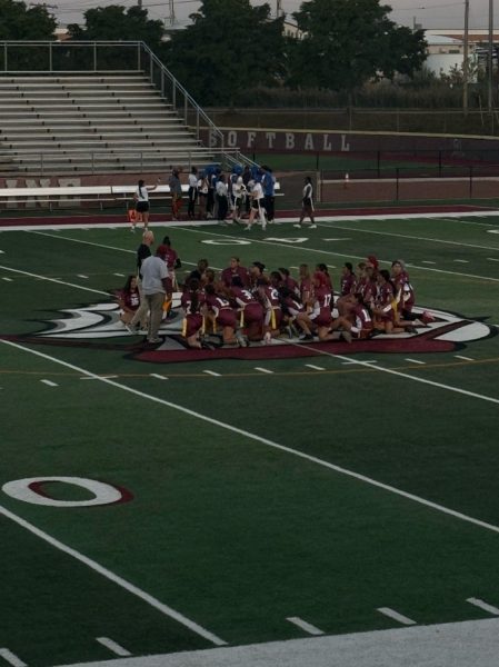 Flag Football team huddled together during half time.
Photo taken by Alaina Skoczylas.
