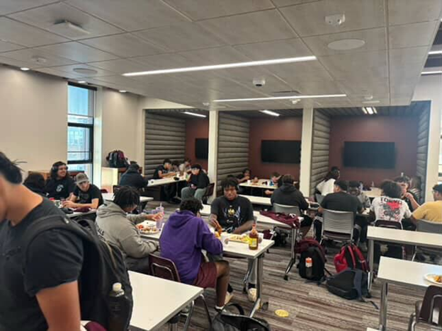 Varsity Football eating their team dinner. Photo by Robin Walker. 