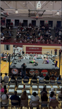 The referee supervises wrestlers during the second half of the Lucha Libre event. Photo taken by Yousef Elshamy 